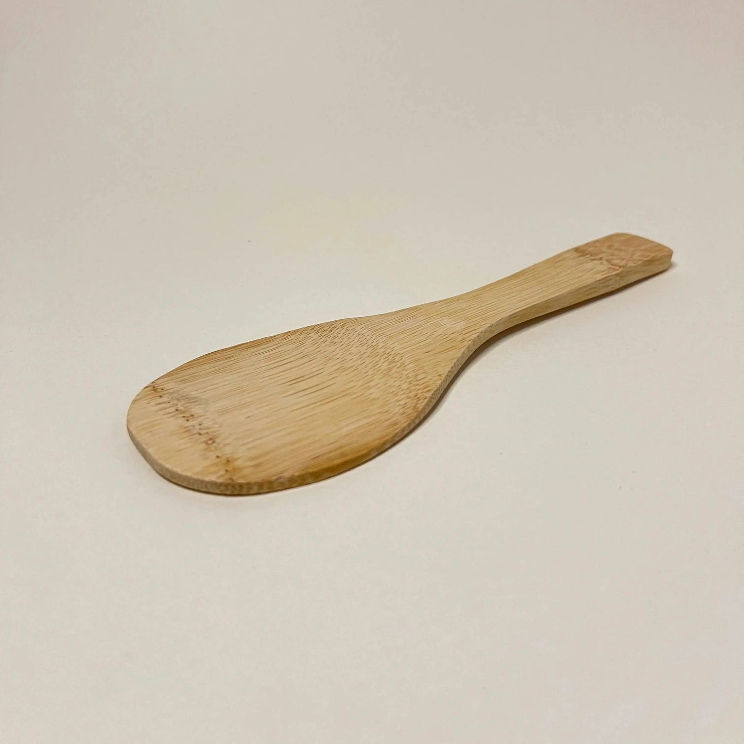 Wooden spoon on a beige background